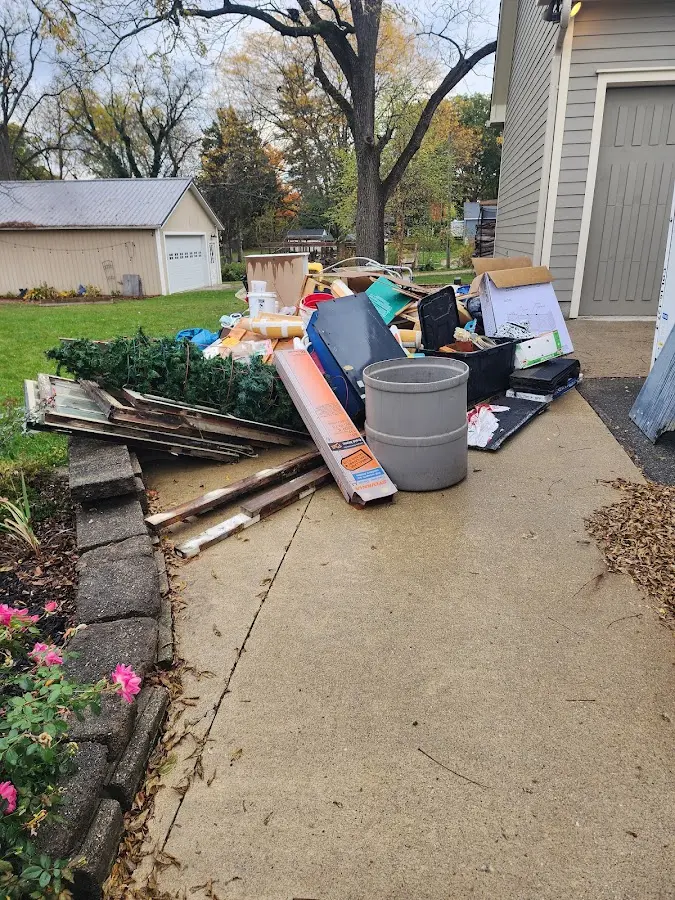 Dumpster being loaded with debris for Estate Cleanout Dumpster Rental in Micco